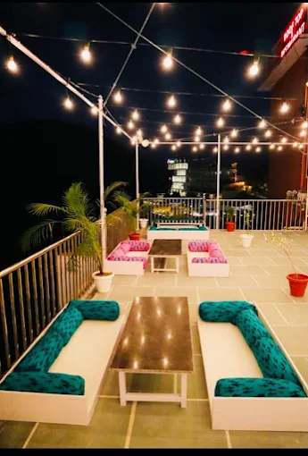 Rooftop lounge seating at Hotel Leopard Valley strung with fairy lights at night